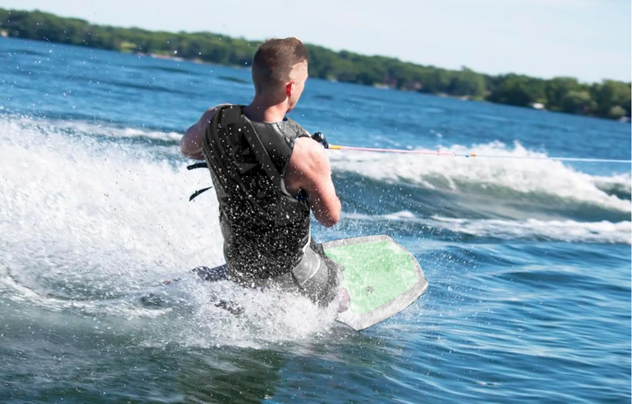 Rider kneeboarding behind the boat